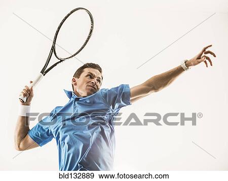Stock Photo - Caucasian man playing tennis. Fotosearch