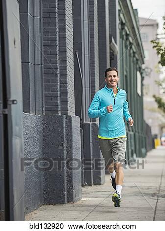 Caucasian man running on city street View Large Photo Image Stock Image - Caucasian man running on city street. Fotosearch