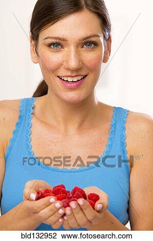 Caucasian woman holding handful of berries View Large Photo Image Stock Image - Caucasian woman holding handful of berries. Fotosearch