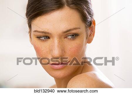 Stock Image - Caucasian woman looking over her shoulder. Fotosearch