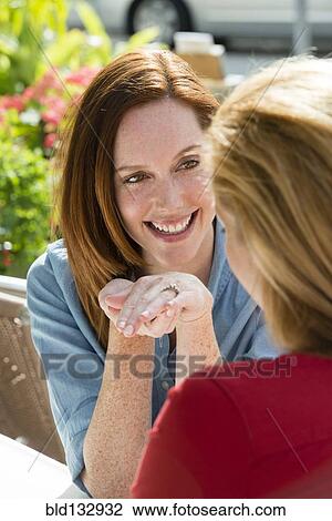 Stock Image - Caucasian woman showing off engagement ring. Fotosearch