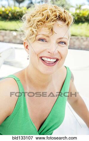 Stock Photo - Caucasian woman smiling on beach. Fotosearch