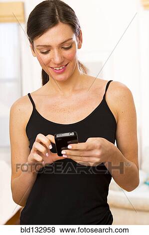 Stock Photo - Caucasian woman using cell phone. Fotosearch