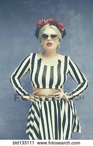 Stock Image - Caucasian woman wearing striped outfit. Fotosearch