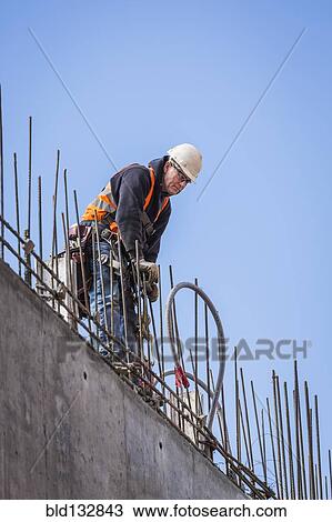 Caucasian worker on top of building View Large Photo Image Stock Image - Caucasian worker on top of building. Fotosearch