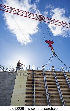 Caucasian worker walking on concrete wall form View Large Photo Image Stock Image - Caucasian worker walking on concrete wall form. Fotosearch