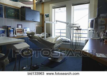 Stock Image - Chair and counters in empty dentist's office. Fotosearch