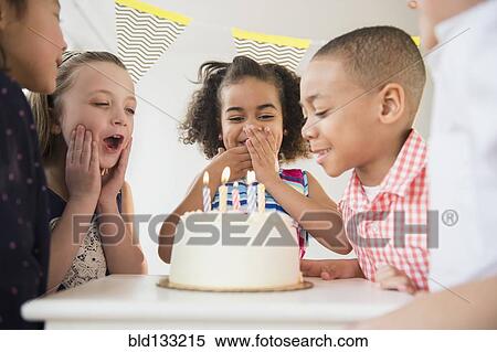 Stock Photography - Children celebrating birthday together. Fotosearch