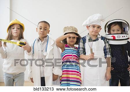 Stock Image - Children playing dress up together. Fotosearch