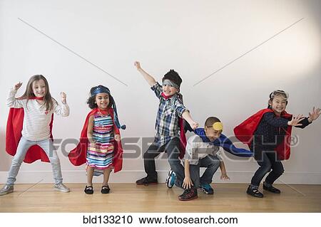 Stock Image - Children playing in capes. Fotosearch