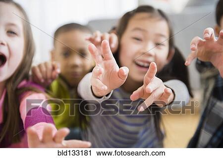 Stock Image - Children playing in living room. Fotosearch
