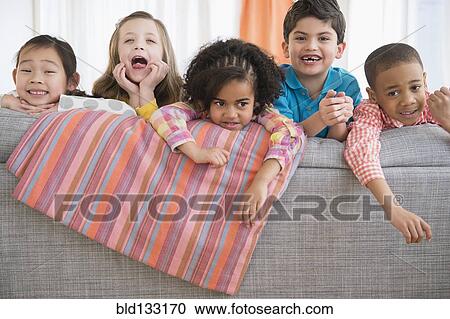 Children playing on sofa View Large Photo Image Stock Image - Children playing on sofa. Fotosearch