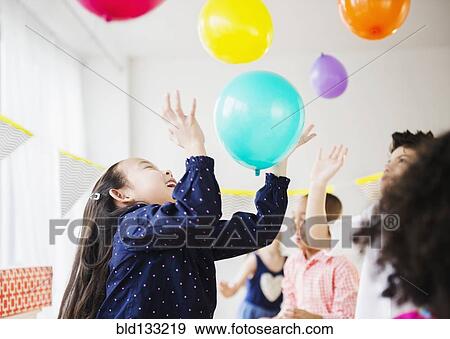 Children playing with colorful balloons at party View Large Photo Image Stock Photo - Children playing with colorful balloons at party. Fotosearch