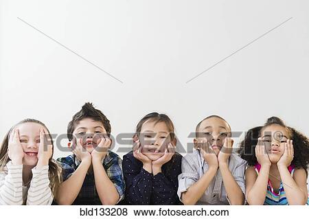 Stock Photo - Children resting chins in hands. Fotosearch
