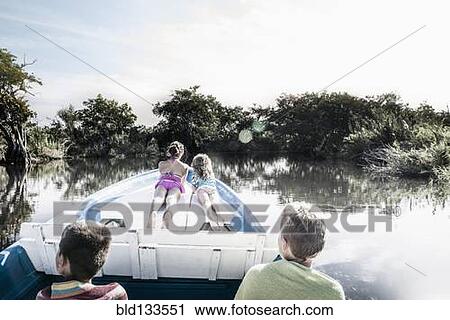 Children riding in canoe on rural lake View Large Photo Image Stock Image - Children riding in canoe on rural lake. Fotosearch