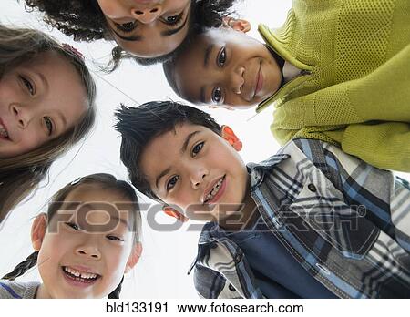 Children smiling in huddle View Large Photo Image Stock Image - Children smiling in huddle. Fotosearch
