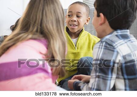 Stock Photo - Children talking in living room. Fotosearch