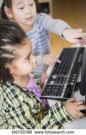 Stock Photo - Children using computer together. Fotosearch