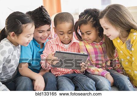 Children using digital tablet together View Large Photo Image Stock Photography - Children using digital tablet together. Fotosearch