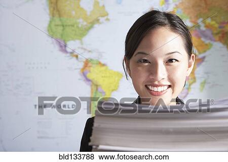 Chinese businesswoman standing by world map View Large Photo Image Stock Photo - Chinese businesswoman standing by world map. Fotosearch