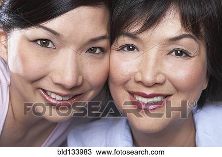 Stock Image - Chinese mother and daughter smiling. Fotosearch