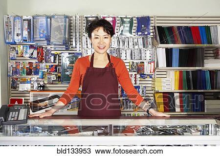 Chinese woman working in office supply store View Large Photo Image Stock Image - Chinese woman working in office supply store. Fotosearch