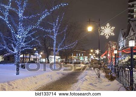Picture - Christmas lights on snowy St Lambert street at night, Quebec, Canada. Fotosearch