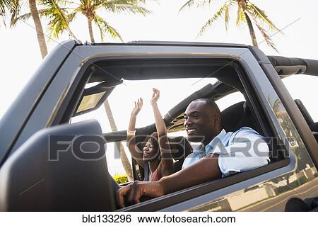 Stock Photograph - Couple driving together in car. Fotosearch