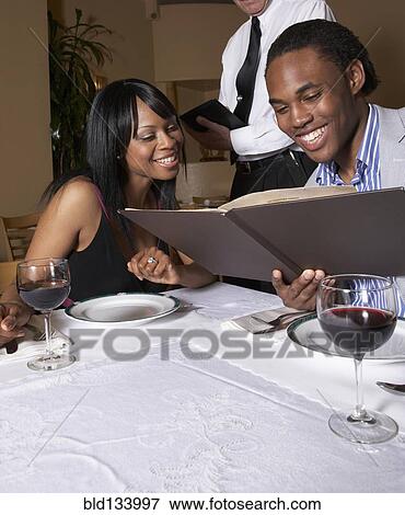 Couple having dinner at restaurant View Large Photo Image Stock Photo - Couple having dinner at restaurant. Fotosearch