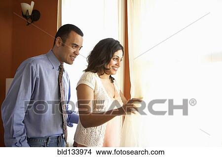 Picture - Couple looking out window. Fotosearch
