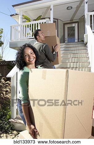 Stock Image - Couple moving into new home. Fotosearch