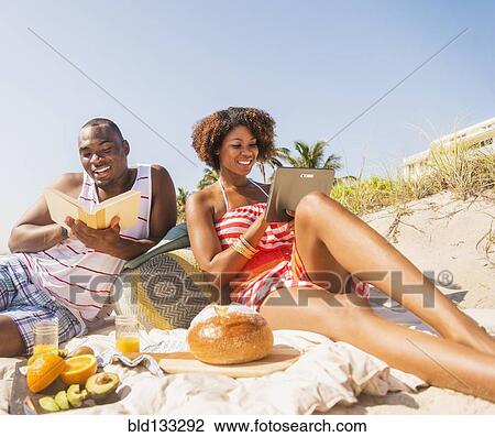 Couple relaxing together on beach View Large Photo Image Stock Image - Couple relaxing together on beach. Fotosearch