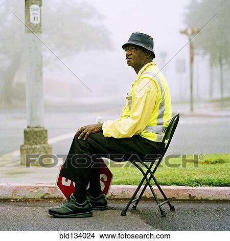 Crossing guard sitting at crosswalk View Large Photo Image Picture - Crossing guard sitting at crosswalk. Fotosearch