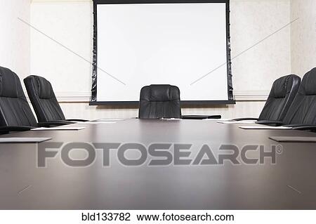 Stock Image - Empty chairs at conference table. Fotosearch