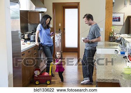 Family relaxing in kitchen View Large Photo Image Stock Image - Family relaxing in kitchen. Fotosearch
