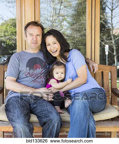 Stock Photograph - Family relaxing together on porch. Fotosearch