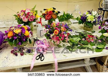 Flower arrangements on work table in florist View Large Photo Image Stock Image - Flower arrangements on work table in florist. Fotosearch