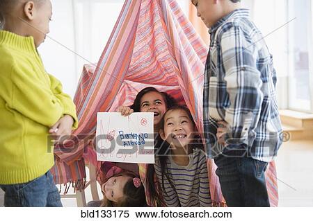 Girls holding No boys Allowed sign in living room View Large Photo Image Stock Photography - Girls holding No boys Allowed sign in living room. Fotosearch