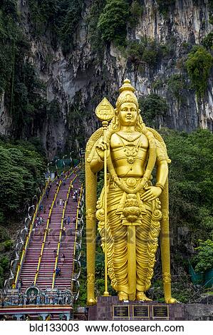 Stock Image - Gold statue of Murugan outside Batu Caves, Kuala Lumpur, Selangor, Malaysia. Fotosearch