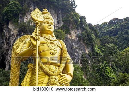 Stock Image - Gold statue of Murugan outside Batu Caves, Kuala Lumpur, Selangor, Malaysia. Fotosearch
