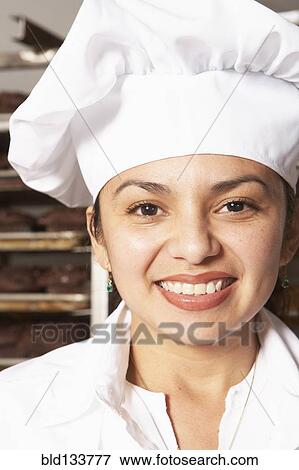 Stock Photo - Hispanic baker smiling. Fotosearch