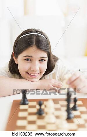Hispanic girl playing chess View Large Photo Image Stock Image - Hispanic girl playing chess. Fotosearch