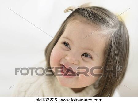 Stock Photography - Hispanic toddler with Down syndrome laughing. Fotosearch