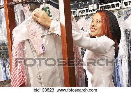 Japanese woman picking up dry cleaning View Large Photo Image Stock Image - Japanese woman picking up dry cleaning. Fotosearch