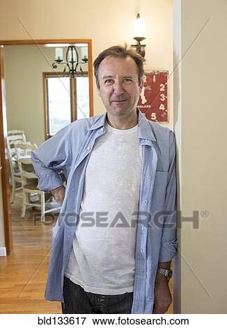 Stock Photo - Man smiling in hallway. Fotosearch