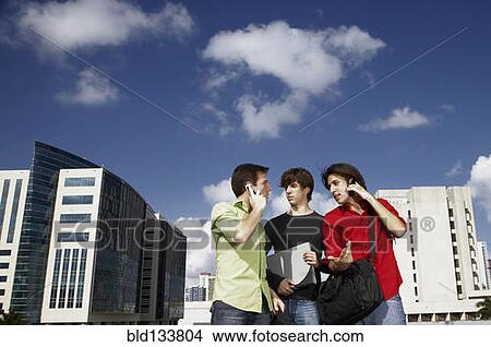 Picture - Men talking on city street. Fotosearch