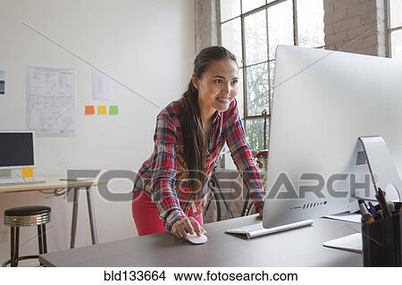 Picture - Mixed race architect working in office. Fotosearch