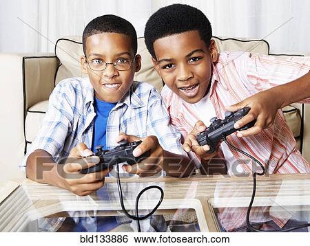 Mixed race boys playing video games View Large Photo Image Stock Photograph - Mixed race boys playing video games. Fotosearch
