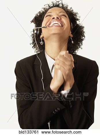 Stock Image - Mixed race businesswoman cheering. Fotosearch