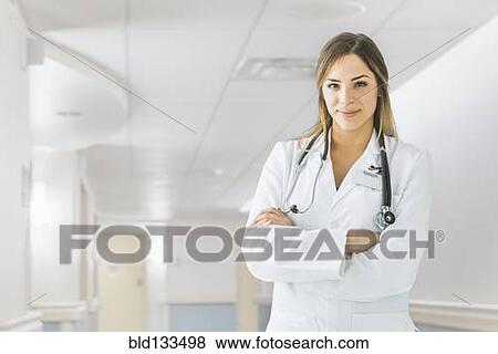 Stock Photo - Mixed race doctor smiling in hospital. Fotosearch